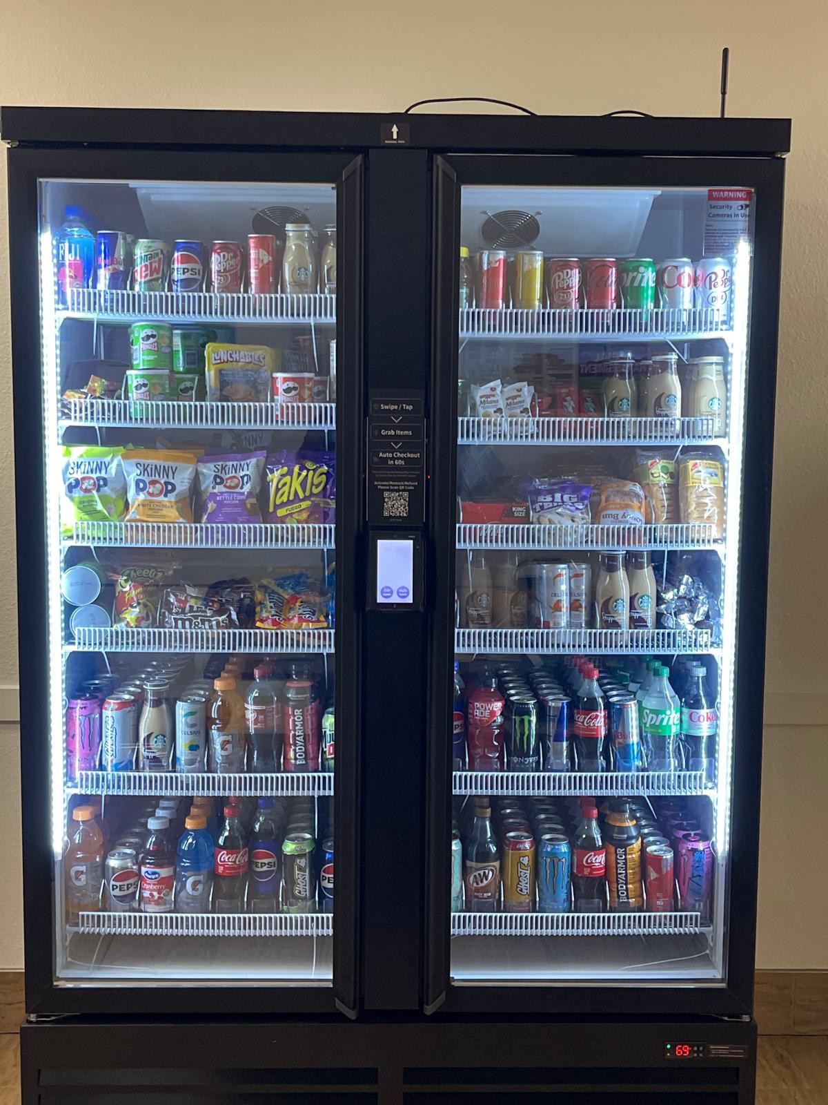 Double-door smart vending machine stocked with snacks and drinks
